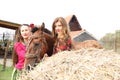 Beautiful gypsy girls in bright clothes with a horse on a farm Royalty Free Stock Photo