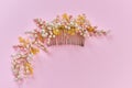 Beautiful hair decoration handmade comb in beads, close-up, pink background Royalty Free Stock Photo