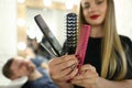 Beautiful Hairdresser Showing Comb and Scissors Royalty Free Stock Photo