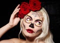 Beautiful Halloween Make-Up Style. Blond Model Wear Sugar Skull Makeup with Red Roses. Santa Muerte concept Royalty Free Stock Photo