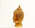 A beautiful hand-carved wooden Buddha head painted in gold