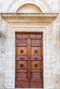 Majestic wooden door in Pienza, Italy.