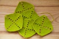 A beautiful hand crocheted pattern pieces of vibrant color gradient in green tones