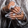 Beautiful hand of the girl with dark skin graft of acrylic nails with nail unusual fotmoy Royalty Free Stock Photo