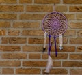 Beautiful hand made dream catcher hanging on a brick wall, home decorations, spiritual background