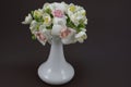 Hand made polymer clay bouquet in a white vase on a dark background