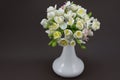 Hand made polymer clay bouquet in a white vase on a dark background