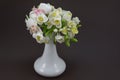 Hand made polymer clay flower bouquet in a white vase on a dark