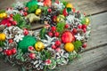 Beautiful hand made traditional bright Christmas wreath decorated with pine cones, spruce branches,berries, balls, stars and Royalty Free Stock Photo