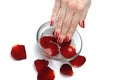 Beautiful hand with nail red manicure and petals Royalty Free Stock Photo