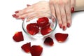 Beautiful hand with nail red manicure and petals Royalty Free Stock Photo