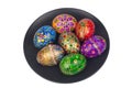 Beautiful hand-painted easter eggs on a large black plate. Isolated image on a white Royalty Free Stock Photo