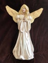 Beautiful Hand Painted Pearl Paint Blonde Female Angel Figurine with Wings on Brown Background Royalty Free Stock Photo