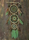 Beautiful handmade boho dreamcatcher with green feathers and beads