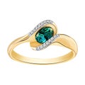 Ring of gold with diamonds and emeralds on white background Royalty Free Stock Photo