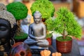 Beautiful handmade statuette of Lord Buddha is displayed in a shop for sale in blurred background. Indian art and handicraft