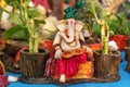 Beautiful handmade statuette of a Lord Ganesha is displayed in a shop for sale in blurred background. Indian art and handicraft