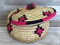 Beautiful Handmade Woven Bamboo / Cane Basket / box with Colourful Woollen Elements. Royalty Free Stock Photo