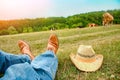 Beautiful hands of a cowboy`s legs in the park on nature Royalty Free Stock Photo