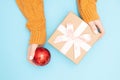 Beautiful hands girl hold gift box present craft paper with pink bow on blue background, top view. Concept Christmas Royalty Free Stock Photo