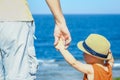 Beautiful hands of parent and child on sea background Royalty Free Stock Photo