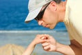 Beautiful hands of parent and child on sea background Royalty Free Stock Photo