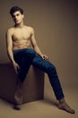 Beautiful handsome muscular male model in blue jeans with perf Royalty Free Stock Photo