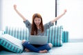 Beautiful happiness portrait of young asian woman using laptop work with success on sofa in the home Royalty Free Stock Photo