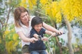 Asian mother and son riding bicycle Royalty Free Stock Photo