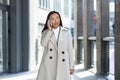 Beautiful and happy asian woman talking on the phone, chinese woman walking during a break near the office, business woman Royalty Free Stock Photo