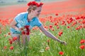 Beautiful blond woman in field with poppies Royalty Free Stock Photo