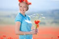 Beautiful blond woman in field with poppies Royalty Free Stock Photo