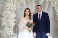 beautiful and happy bride and groom in an arch of flowers at wedding ceremony Royalty Free Stock Photo