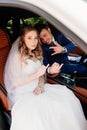 A beautiful and happy bride and the groom sit in cars. Rent transport