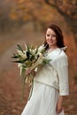 beautiful happy bride holding wedding autumn bouquet