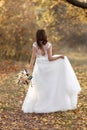 beautiful happy bride holding wedding autumn bouquet