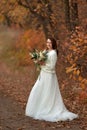 beautiful happy bride holding wedding autumn bouquet Royalty Free Stock Photo