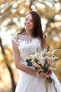 beautiful happy bride holding wedding autumn bouquet Royalty Free Stock Photo