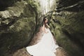 Beautiful happy bride outdoors in a forest with rocks. Wedding perfect day Royalty Free Stock Photo