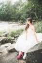 Beautiful happy bride outdoors in a forest with rocks. Wedding perfect day Royalty Free Stock Photo