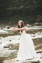 Beautiful happy bride outdoors in a forest with rocks. Wedding perfect day Royalty Free Stock Photo