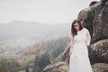 Beautiful happy bride outdoors in a forest with rocks. Wedding perfect day Royalty Free Stock Photo