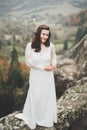 Beautiful happy bride outdoors in a forest with rocks. Wedding perfect day Royalty Free Stock Photo