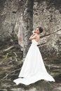 Beautiful happy bride outdoors in a forest with rocks. Wedding perfect day Royalty Free Stock Photo