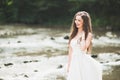 Beautiful happy bride outdoors in a forest with rocks. Wedding perfect day Royalty Free Stock Photo