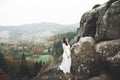 Beautiful happy bride outdoors in a forest with rocks. Wedding perfect day Royalty Free Stock Photo