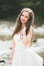 Beautiful happy bride outdoors in a forest with rocks. Wedding perfect day Royalty Free Stock Photo