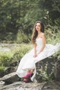 Beautiful happy bride outdoors in a forest with rocks. Wedding perfect day Royalty Free Stock Photo