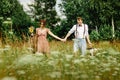 beautiful happy bride and stylish retro groom with basket holding hands, picnic time Royalty Free Stock Photo