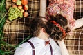 beautiful happy bride and stylish retro groom lying on tweed blanket, cuddling and relaxing, picnic in sunny meadow Royalty Free Stock Photo